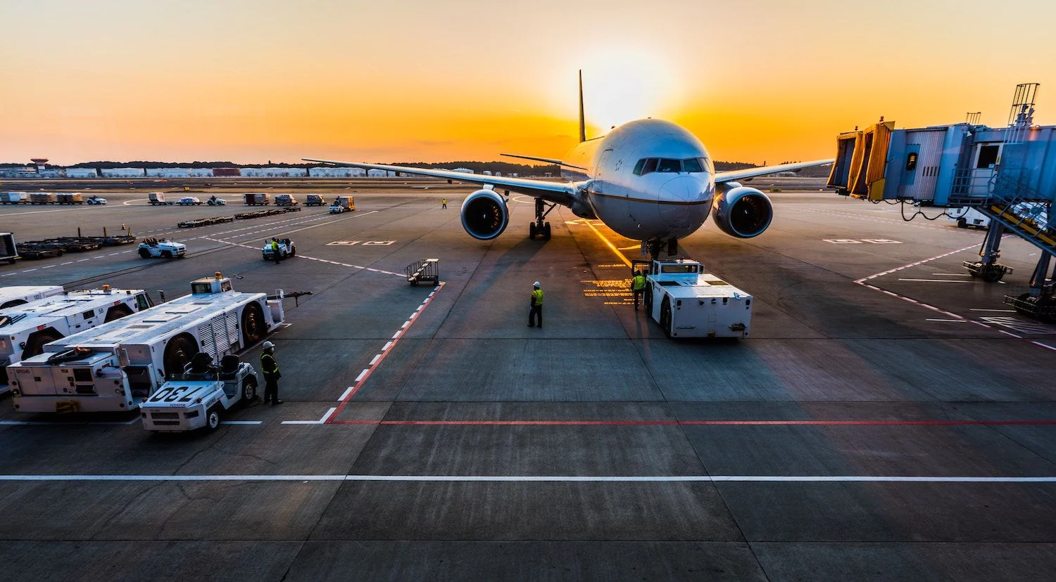 Aircraft at an airport terminal at sunset Aircraft at an airport terminal at sunset
