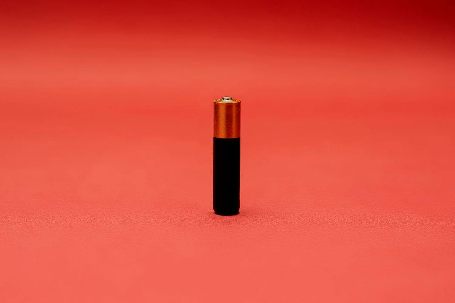 Image of AA battery on red background